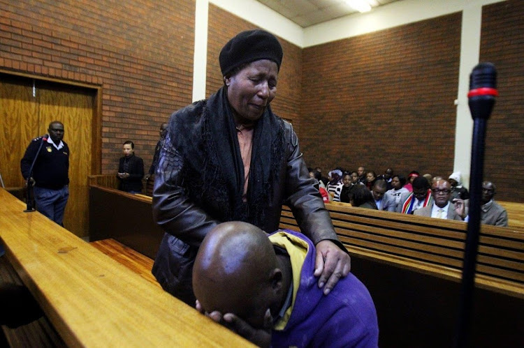 Sibusiso Emmanuel Tshabalala is comforted during a court appearance after he shot dead his son Luyanda earlier this year.