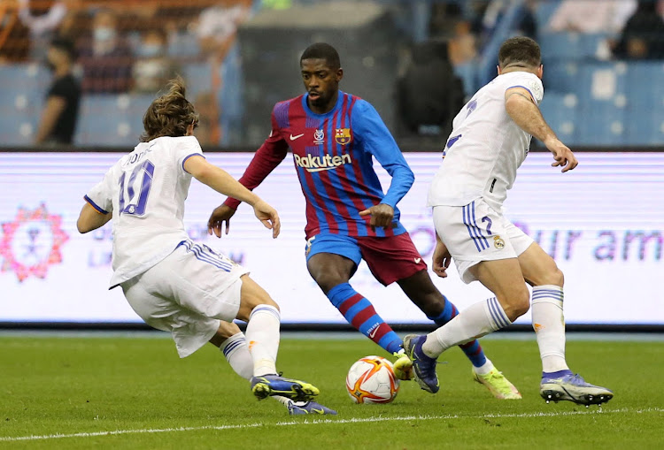 FC Barcelona's Ousmane Dembele in action with Real Madrid's Luka Modric