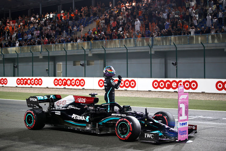 Pole position qualifier Lewis Hamilton celebrates in parc ferme during qualifying ahead of the F1 Grand Prix of Qatar at Losail International Circuit on November 20, 2021 in Doha, Qatar.