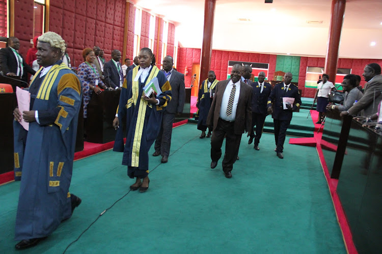 Homa Bay deputy speaker Elias Orondo, clerk Faith Apuko and Governor Cyprian Awiti leave the chamber after Awiti delivered state of the county address in Homa Bay town on April 12, 2022