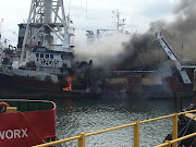 Emergency workers have treated 80 crew members for smoke inhalation after a fishing trawler caught alight at Durban's Bayhead area. 