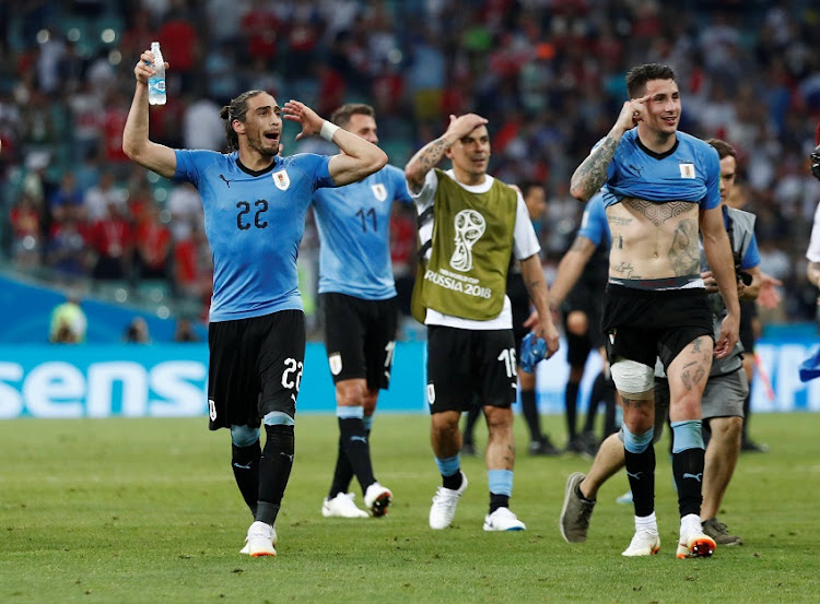 Uruguay's Luis Suarez, Jose Gimenez and team mates celebrate after the match.