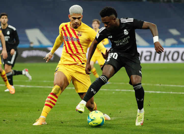 Barcelona's Ronald Araujo in action with Real Madrid's Vinicius Junior