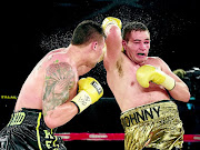 GRUDGE DUEL: Johnny Muller, right, blocks Kevin Lerena's punch during their fight which Muller won on points after 10 rounds in 2014 
      PHOTO: n-Squared