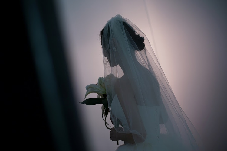 Peng Jing, 24, smiles during her wedding photography shoot after the lockdown was lifted in Wuhan.