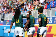 Cecil Afrika, Siviwe Soyizwapi, and Ruhan Nel of South Africa celebrate after scoring a try against Argentina during day 2 of the 2018 HSBC USA Sevens at Sam Boyd Stadium on March 03, 2018 in Las Vegas, United States of America. 