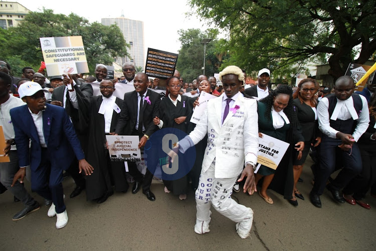 High Court Advocate Shadrack Wambui donning a suit of sacks during the LSK demos outside Supreme Court on January 12, 2024.