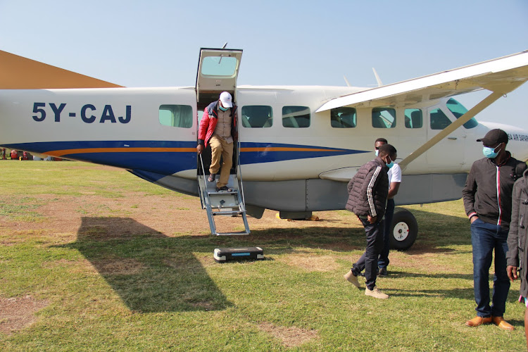 Passengers alight from Mombasa Air Safari plane at Kabunde airstrip in Homa Bay town on June 11,2021