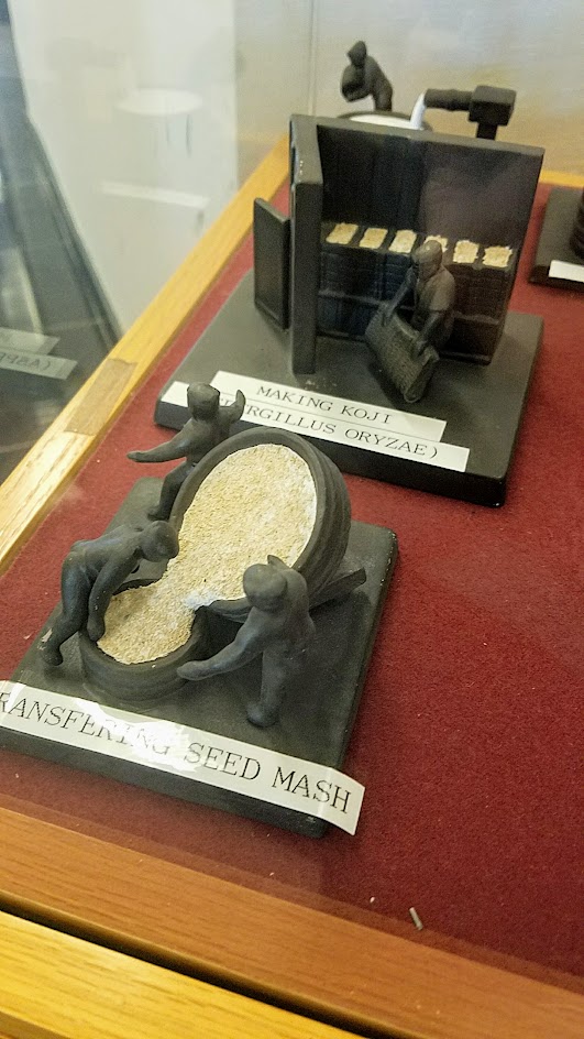 Figures showing the multiple steps in the process of brewing sake, in a display case when visiting Gekkeikan USA in Folsom