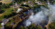 Firefighters tackle a grass fire during the heatwave in Mow Cop, Staffordshire, Britain, July 19, 2022.  