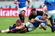 Namibia fullback Johan Tromp is tackled by New Zealand's George Bridge and Jack Goodhue during their Rugby World Cup pool game. Namibia will go home with a decidedly bitter taste in the mouth.