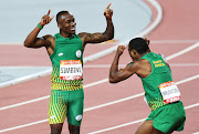 Akani Simbine celebrates with Henricho Bruintjies.