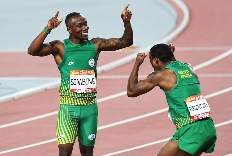 Akani Simbine celebrates with Henricho Bruintjies.