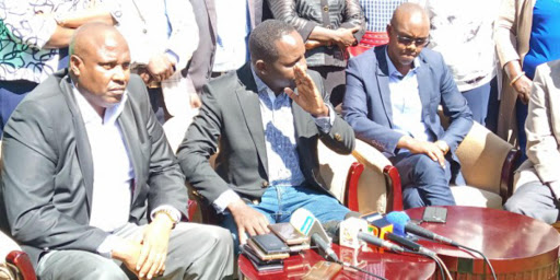 Marakwet East MP Kangogo Bowen (c) with Speaker Phillemon Sabulei and Marakwet West MP William Kisang speaking in Eldoret on March 9th