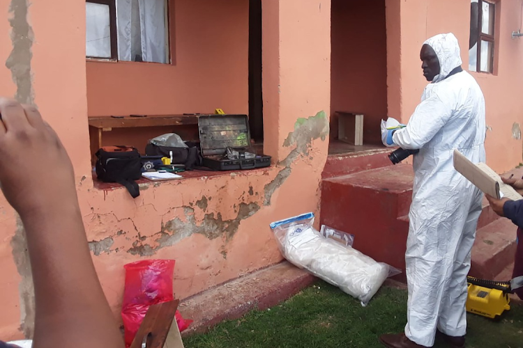 Crime scene experts comb the area around the home where seven members of a family were shot dead in Tantseka village, near Qunu, on Wednesday night.