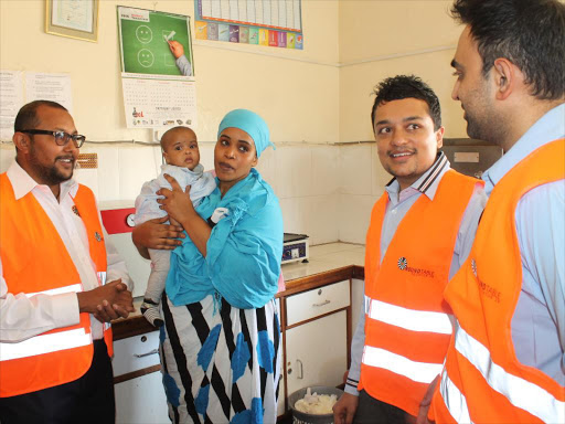 A team of doctors led by Metal Shah (left) drawn from Round Table Equator organisation with a patient during a free medical camp in Kisumu town/MAURICE ALAL