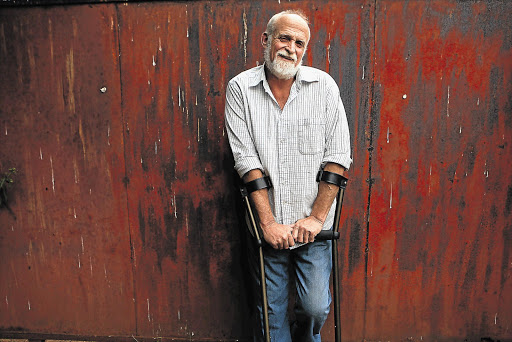 Photographer John Liebenberg, known for his pictures of the Namibian border war, at his home in Johannesburg. Fellow photographers have donated their work for auction to raise funds for Liebenberg to undergo surgery to his hip