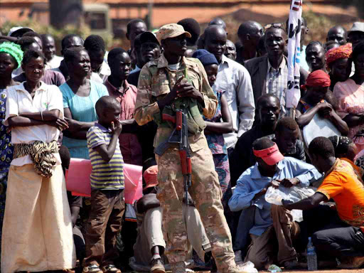 A member of the South Sudan National Security Services (SSNSS) stands guard as South Sudan Vice President Taban Deng Gai addresses civilians at the Freedom Square in Yei, southwest of the capital Juba, South Sudan December 31, 2016. /REUTERS