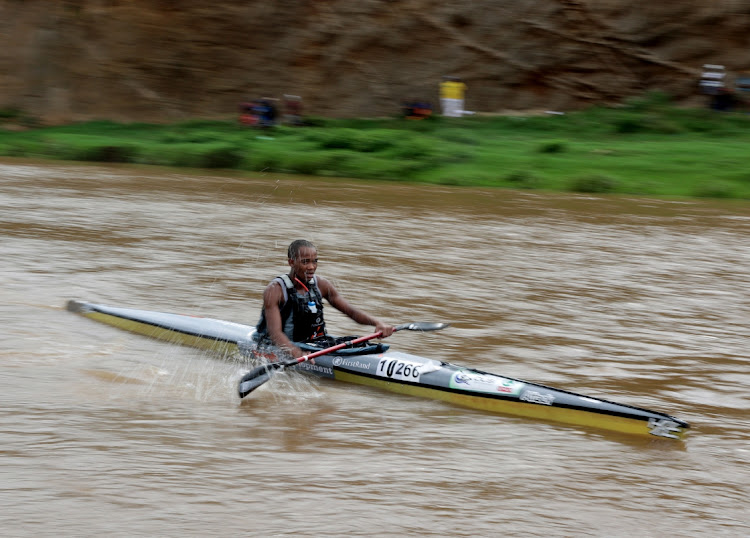 Wongama Makasi, 22, gets help from the water as he finishes the first day of the Dusi at KwaXimba.