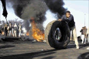 ROAD CLOSED: Residents of Organe Farm burn tyres and block the roads during protests over lack of service delivery in the township yesterday.  19/05/2009. Pic. Sechaba Nhlapo. © Sowetan.