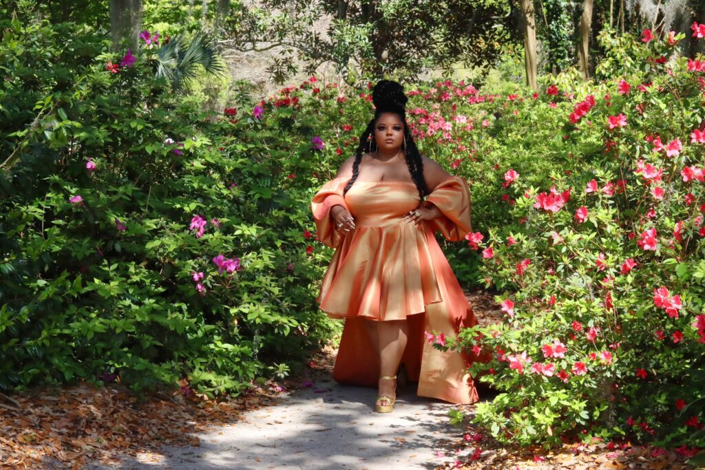 This image has an empty alt attribute; its file name is Courtney-Noelle-Plus-Size-Dresses-Ivy-Orange-Gown-with-Train-Front-View-1024x683.jpg