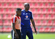 Orlando Pirates' caretaker coach Rulani Mokwena in a discussion with midfielder Siphesihle Ndlovu at the club's Rand Stadium training base on September 11 2019.  