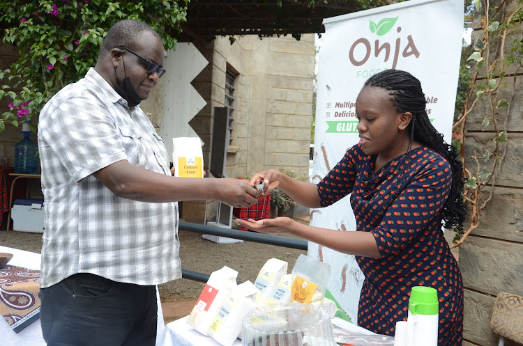 SESOK chairman Peter Oloo samples a piece of cake that is made of chickpea from Onja Foods founder Mary Karuk