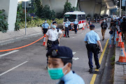 Police officers stand guard after the sentencing of pro-democracy activists Joshua Wong, Agnes Chow and Ivan Lam, at West Kowloon Magistrates' Courts in Hong Kong, China December 2, 2020. 