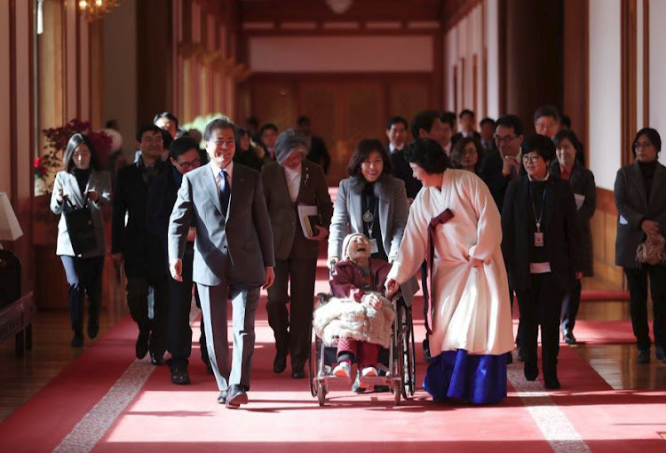 South Korean President Moon Jae-in and first lady Kim Jung-Suk greet a South Korean woman who was forced to work in Japanese wartime brothels as a "comfort woman", at the Presidential Blue House in Seoul, South Korea, January 4, 2018.