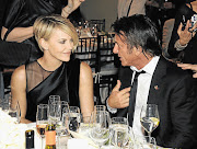 FULLY COCKED: Charlize Theron and Sean Penn at the Help Haiti Home gala in Beverly Hills last week, at which he offered his collection of 65 weapons for auction. Picture: GETTY IMAGES