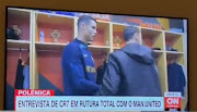 A screenshot of a video shared on Twitter of television footage showing an awkward handshake between Manchester United teammates Cristiano Ronaldo and Bruno Fernandes greeting as they arrive in Portugal's squad camp ahead of the 2022 World Cup.