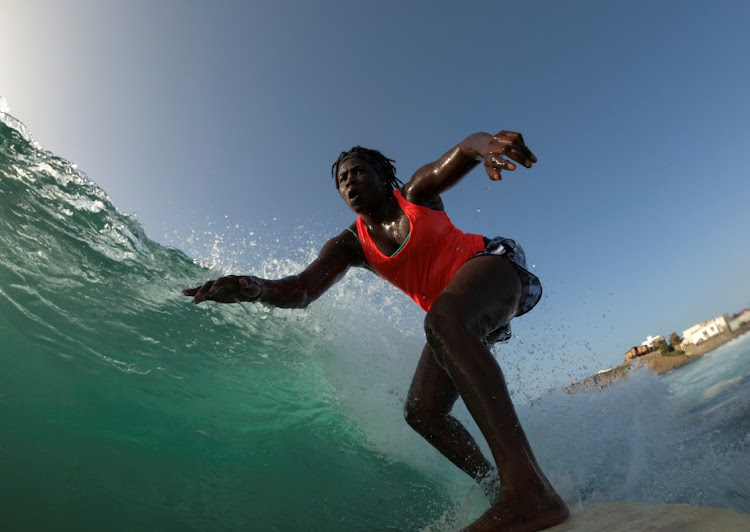 Khadjou Sambe, 25, Senegal's first female professional surfer, surfs during a training session off the coast of Ngor, Dakar, Senegal, on August 18, 2020.