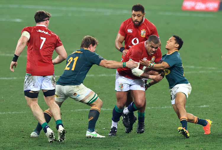 Kyle Sinckler of British and Irish Lions is tackled by Kwagga Smith and Herschel Jantjies of SA during the second Test in Cape Town on July 31, 2021