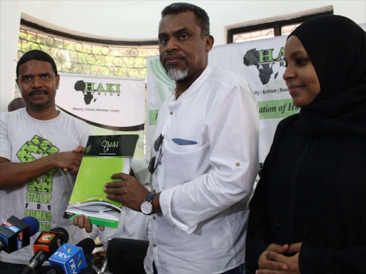 DPP Noordin Haji receives a report containing names of people allegedly killed by the police at the Coast from HAKI-Africa officials Hussein Khalid and Salma Hemed on Sunday, September 9, 2018. /MALEMBA MKONGO