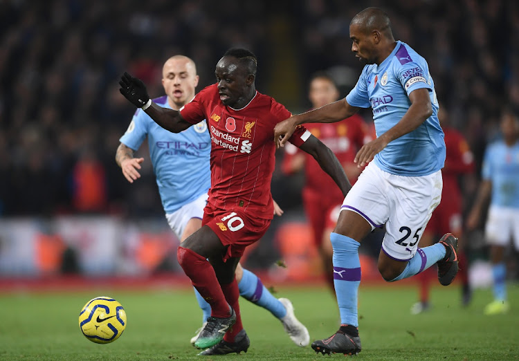 Sadio Mane of Liverpool battles for possession with Fernandinho of Manchester City during the Premier League match at Anfield on November 10, 2019 in Liverpool