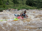 A man controls his canoe as he paddles down the fast-flowing Umgeni River on day one of the Dusi. 