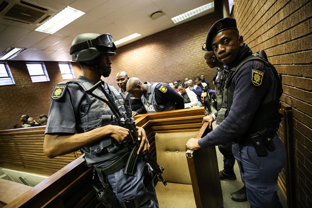 Members of the Tactical Response Team at the in the Roodepoort Magistrates court in the West Rand, Johannesburg monitor the court rooms where four men are appearing in connection with a cash in transit heist, one of them a former ANC Luthuli House employee, 31 July 2018