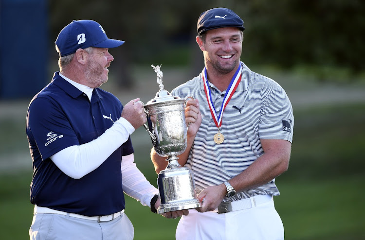 Bryson DeChambeau (right) and his caddie Tim Tucker celebrate with the trophy after winning the US Open at Winged Foot Golf Club, Mamaroneck, New York on October 20