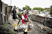 HUSTLING: Phillip Mhlanga, 15, selling his wares in Alexandra, Johannesburg. He tries to send money back to his family in Mozambique. Despite living in one of South Africa's most impoverished communities, he believes life here is better than in his home country.