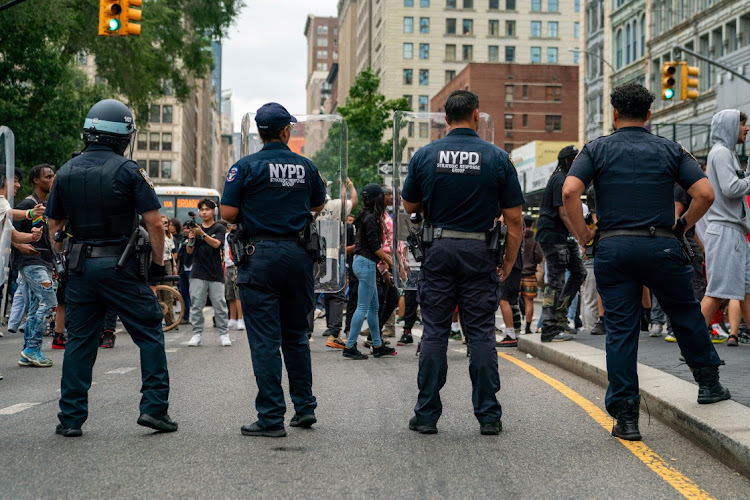 Police officers stand guard as people gather after popular live streamer Kai Cenat announced a "giveaway" event that grew chaotic, prompting police officers to respond and disperse the crowd at Union Square and the surrounding streets, in New York City, US August 4, 2023.