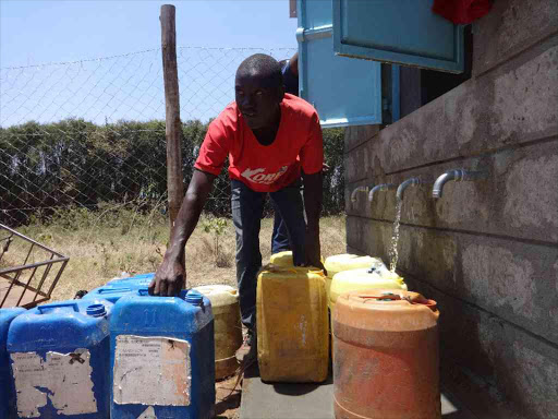 Kizito resident draws water at the Sh6 million water project commissioned on Friday by Governor William Kabogo. e borehole will serve over 300,000 residents from Githurai and environs / JOHN KAMAU