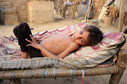 Hassan Merzam Muhammad lies on a bed at his family's hut in Hajjah province, Yemen. This picture was taken on November 23 2020.