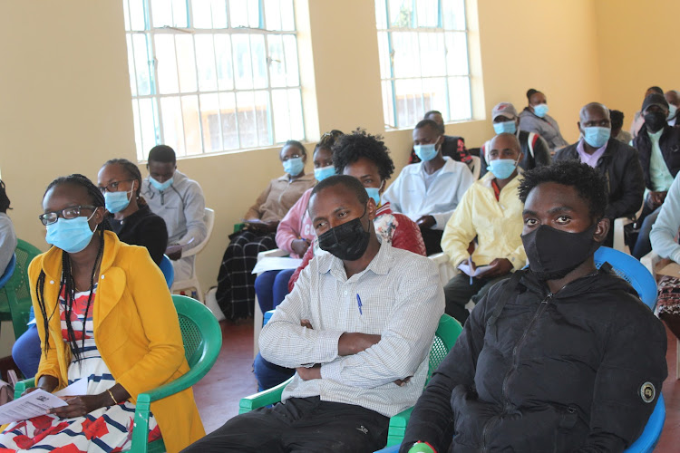 Participants follow proceedings during a youth development policy public participation event at Mweiga NG-CDF hall in Kieni West Sub County on Monday