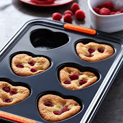 Raspberry heart friands prepared in a six-cup heart tray from Le Creuset.