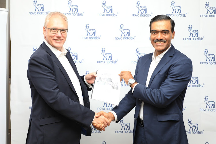 MYDAWA managing director Tony Wood and Novo Nordisk vice-president Vinay Ransiwal exchange the signed MOU that solidifies the teams' partnership on April 22, 2022