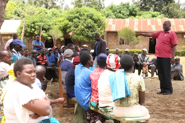 Ruuju borehole community members being addressed by area MCA Gabriel Chokera