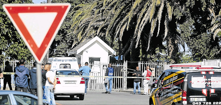 Emergency services and police outside Voorpos Primary School yesterday, where a policeman allegedly shot and killed his wife at the school.