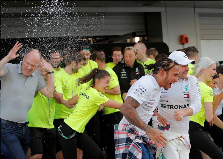 Mercedes' Lewis Hamilton and Mercedes' Valtteri Bottas celebrate after finishing in first and second place respectively at the F1 Russian Grand Prix at the Sochi Autodrom, Sochi, Russia on September 29 2019