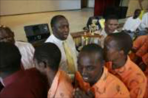 RECOGNITION: Prison chief Tami Tyobo hands out trophies to Boksburg Correctional Services league winners in Ekurhuleni. Pic. Antonio Muchave. 14/11/06. © Sowetan.