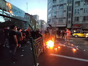 People light a fire during a protest over the death of Mahsa Amini, a woman who died after being arrested by the Islamic republic's 